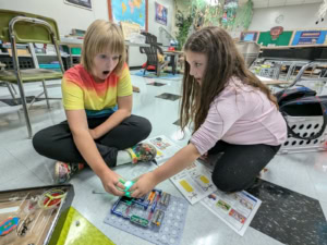 Rylyn Parrett (left) and Avery Colvin (right) are pictured using snap circuits.